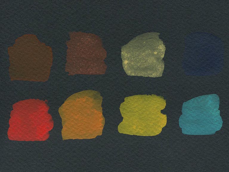 swatching paints over black watercolour paper