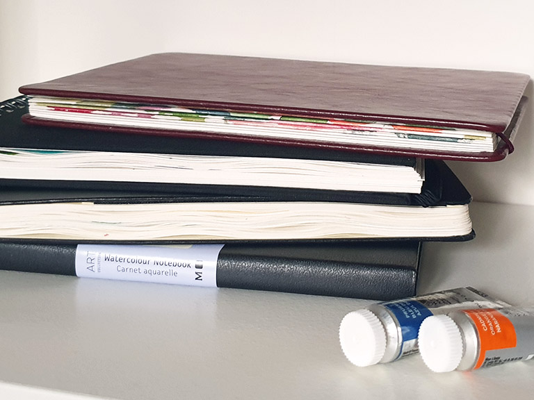 stack of watercolour sketchbooks